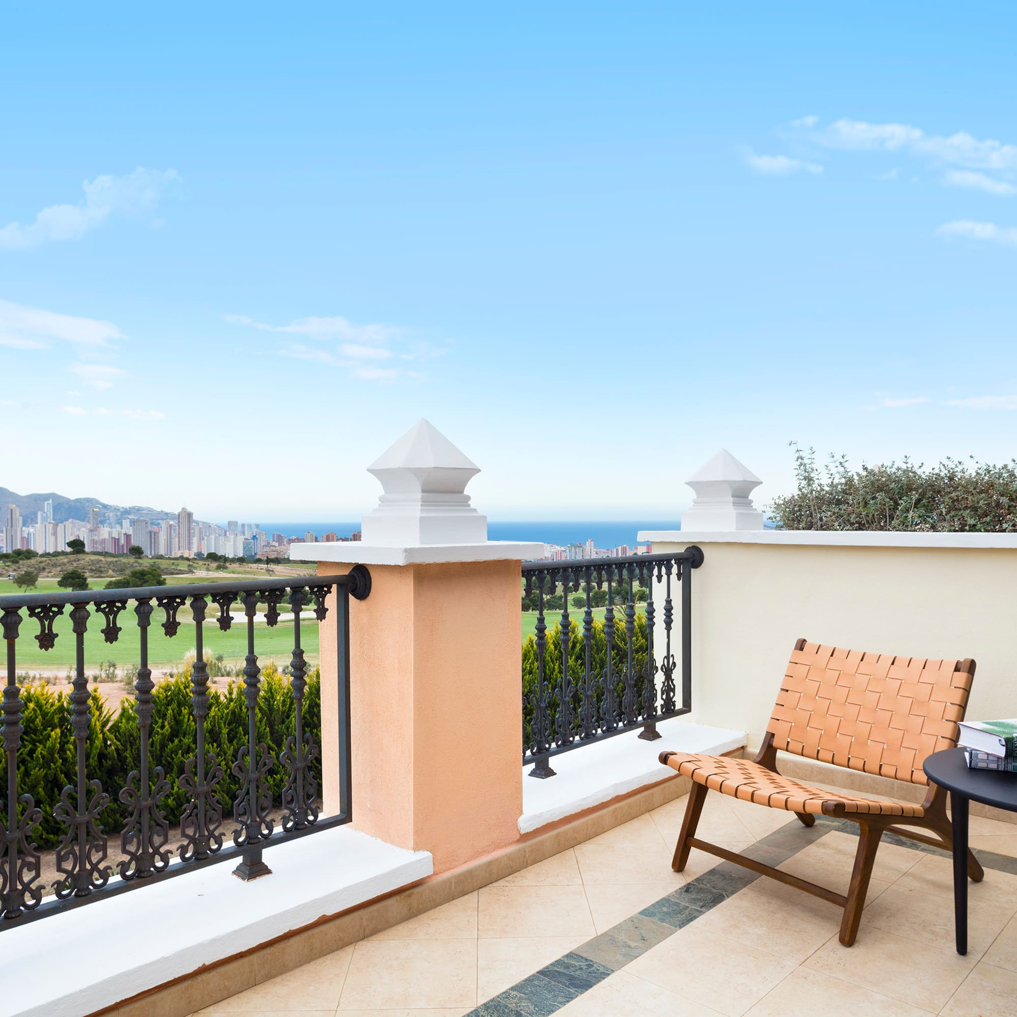 a chair and table on a balcony