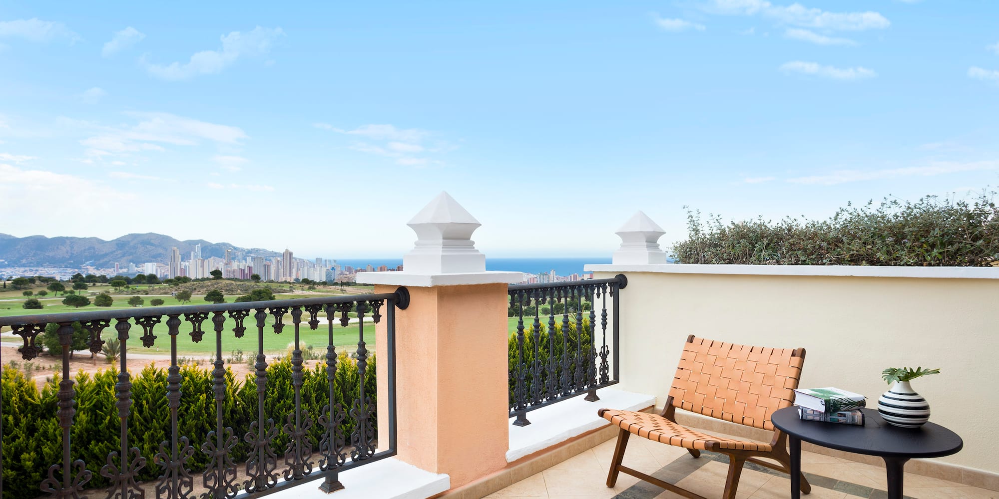 a chair and table on a balcony