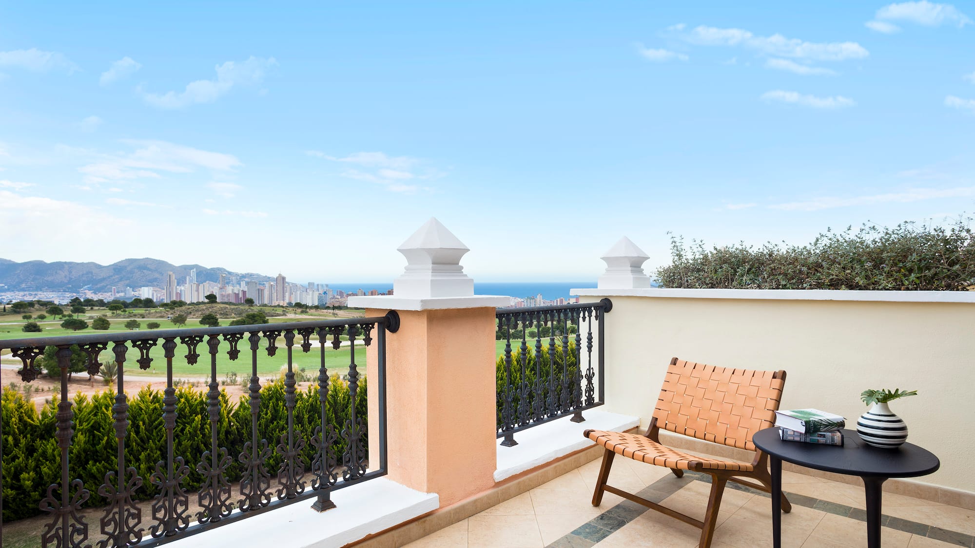 a chair and table on a balcony