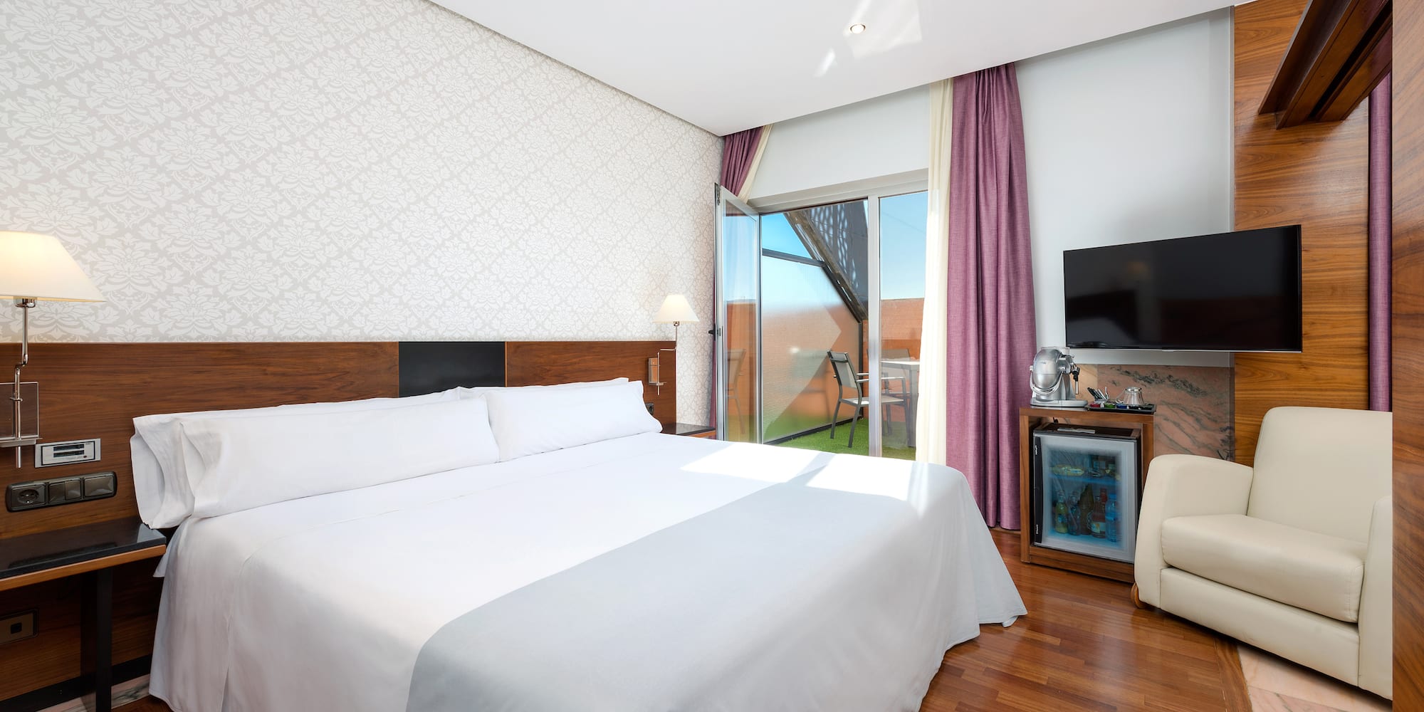 a room with a bed and a television