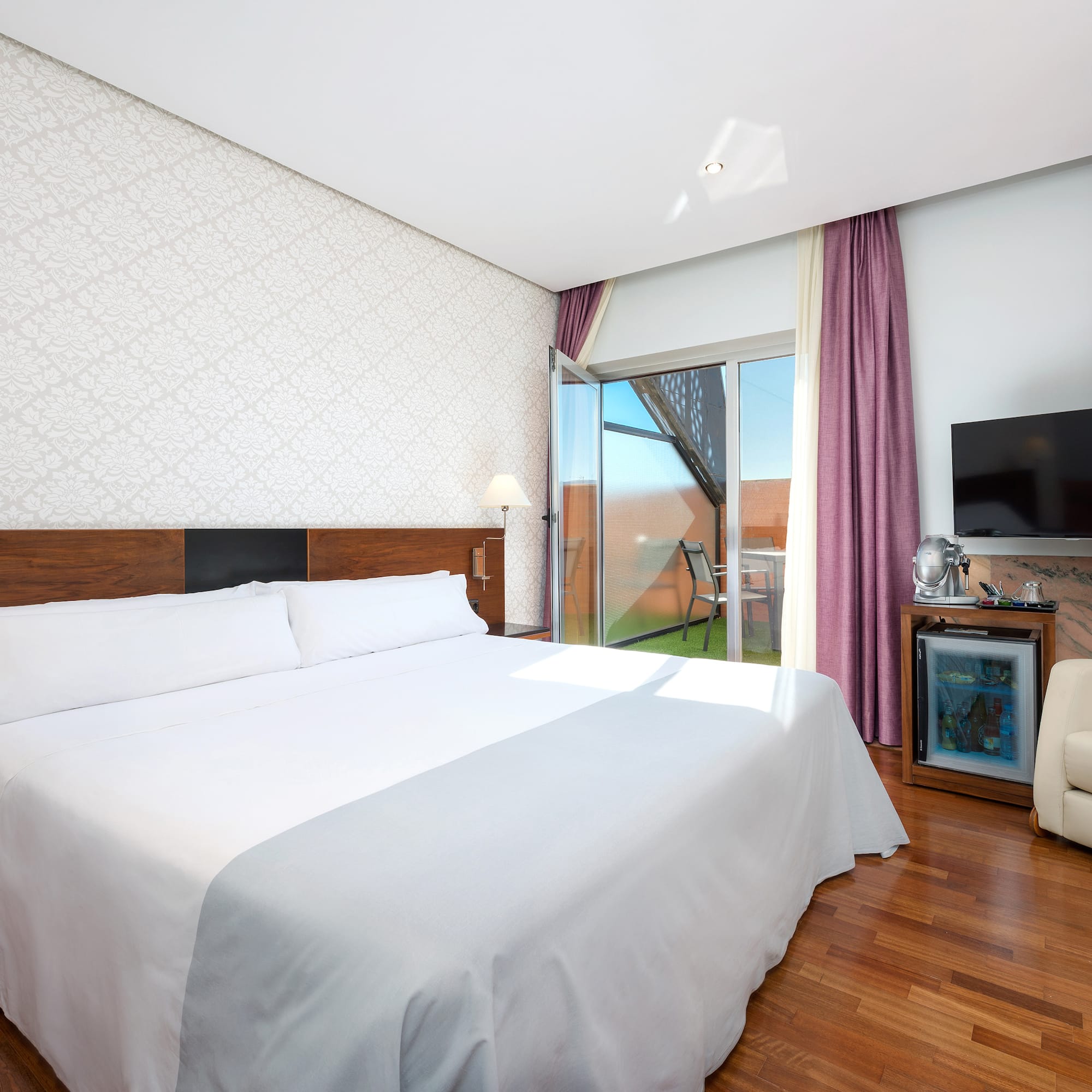 a room with a bed and a television