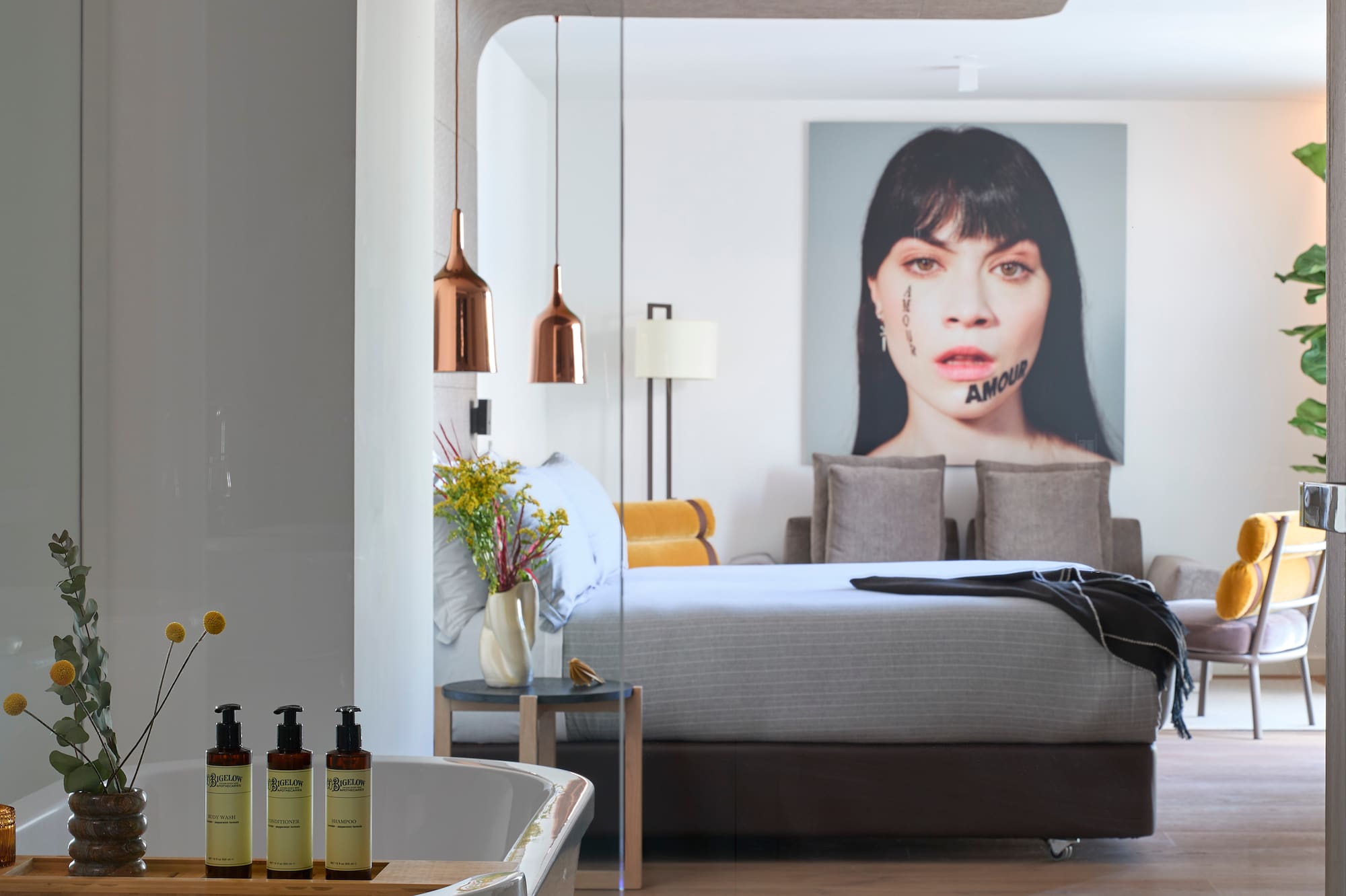 a bedroom with a bed and a picture of a woman