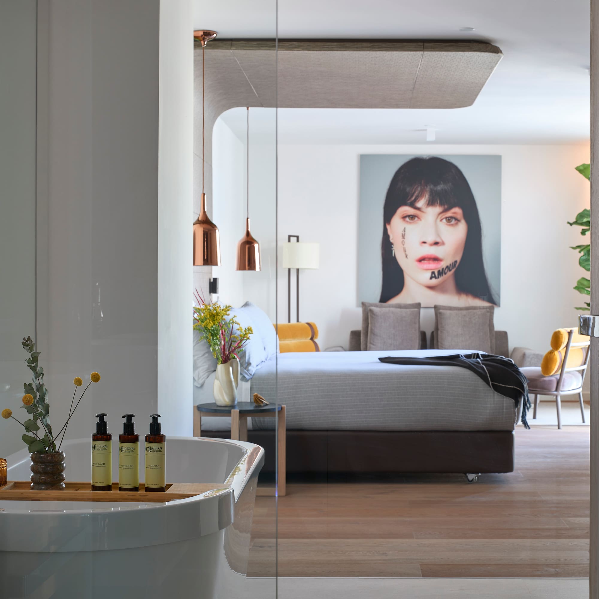 a bedroom with a bed and a picture of a woman