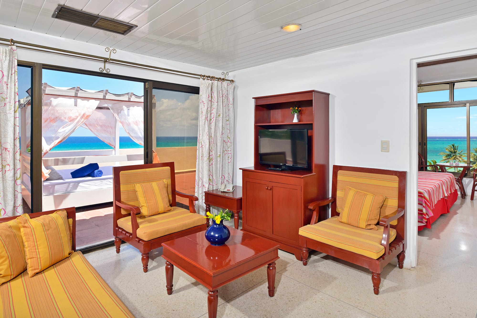 a living room with a television and chairs