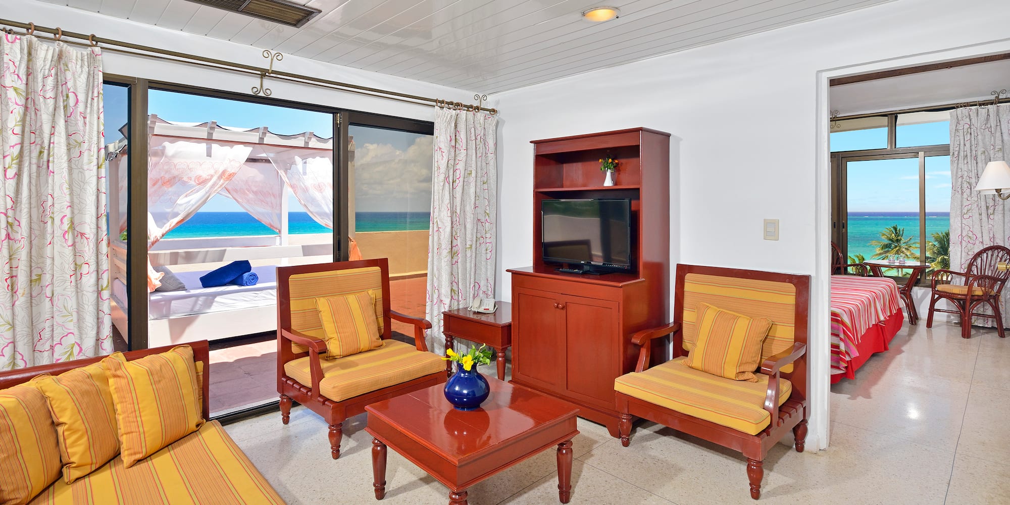 a living room with a television and chairs