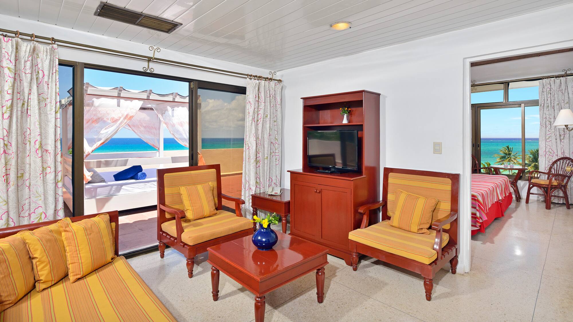 a living room with a television and chairs