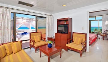 a living room with a television and chairs