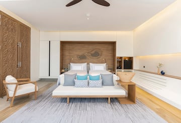 a room with a bed and a fan