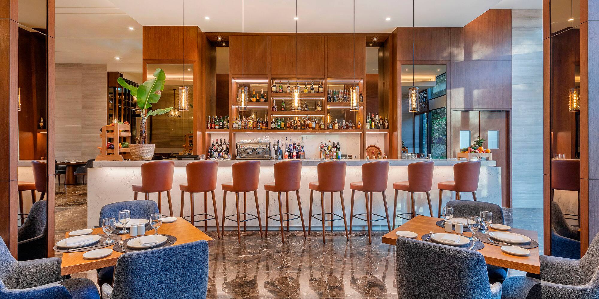 a restaurant with a bar and chairs