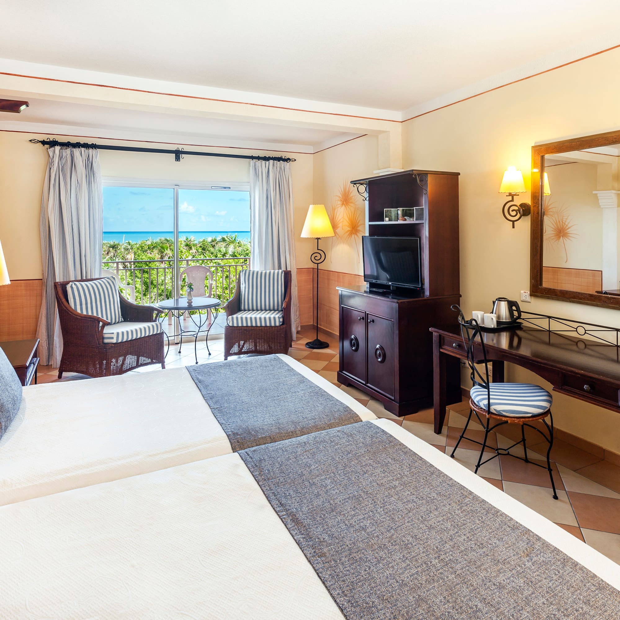 a room with two beds and a television