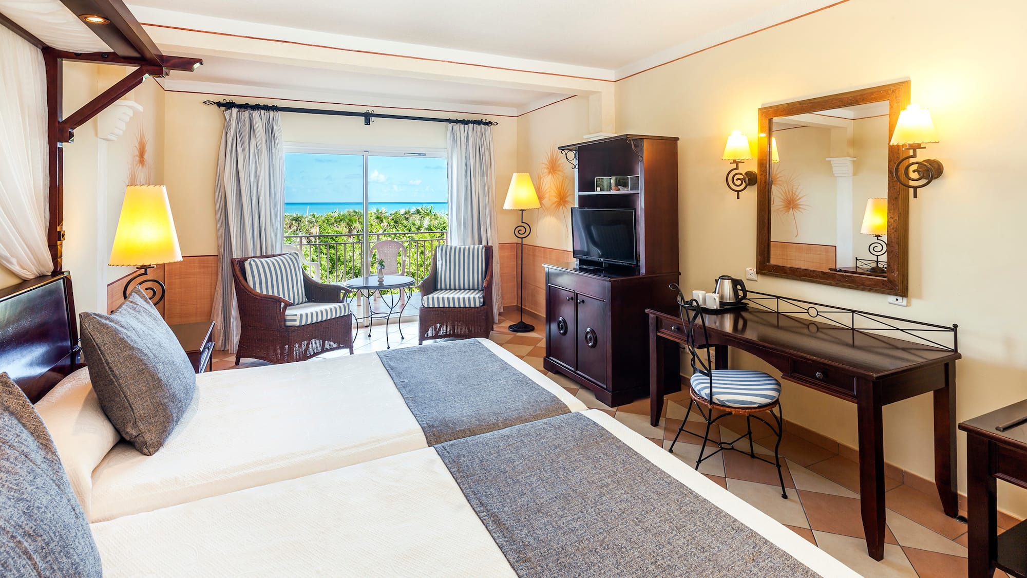 a room with two beds and a television