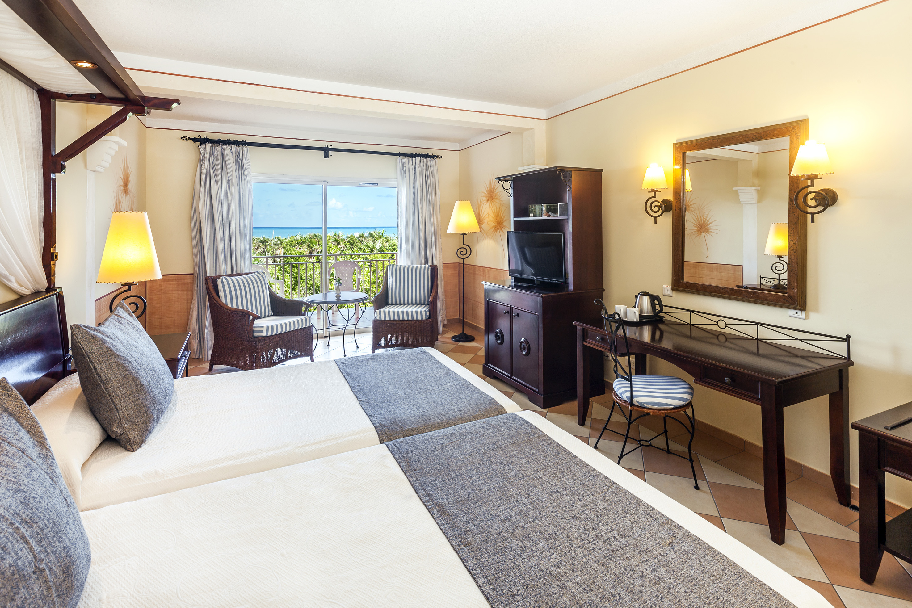 a room with two beds and a television