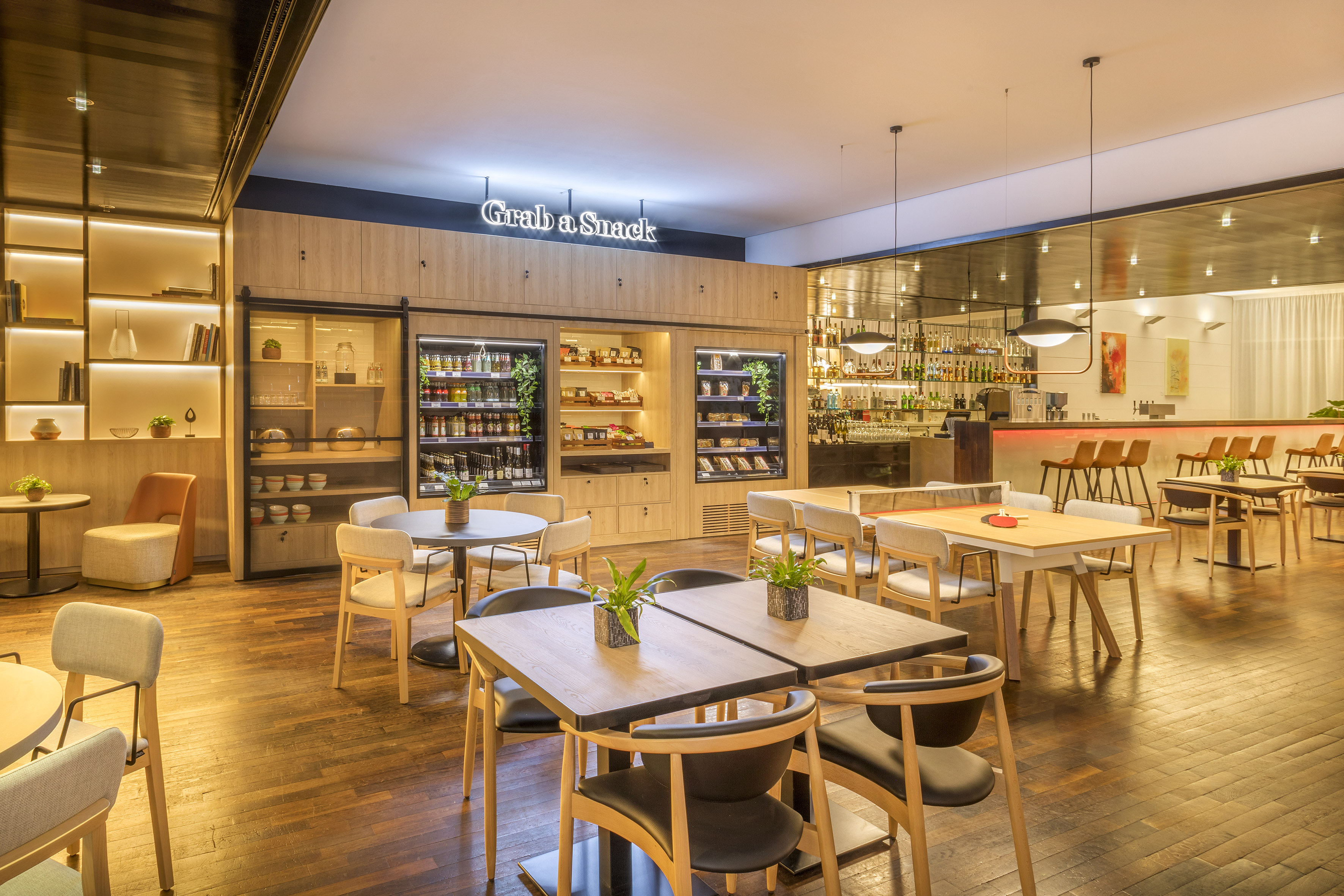 Hotel lobby cafe with 'Grab a Snack' station, modern dining, and bar.
