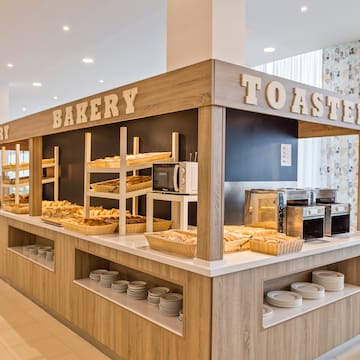 a bakery with many breads on shelves