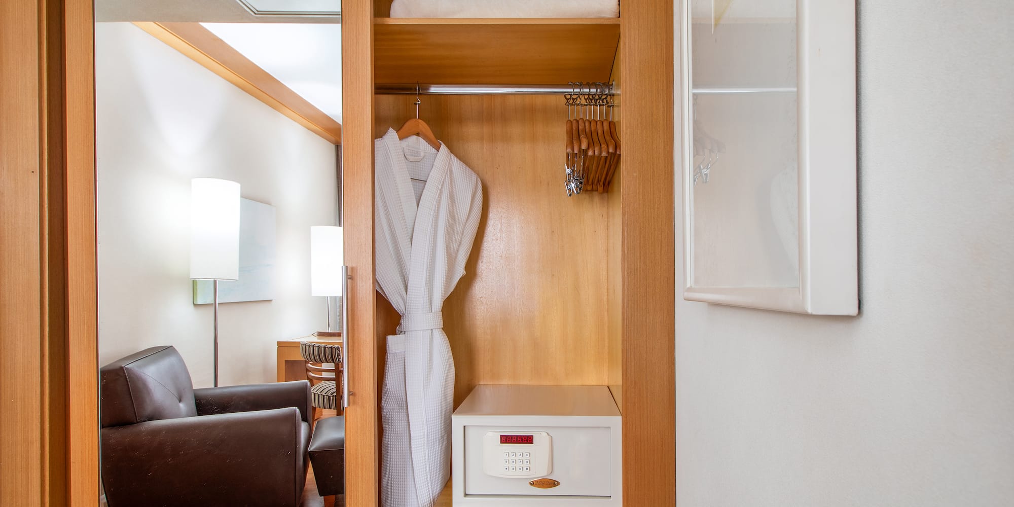 a white robe on a swinger in a closet