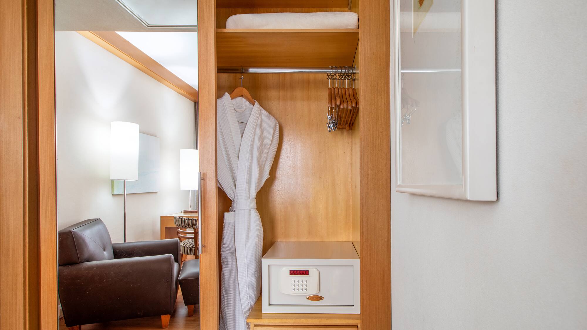 a white robe on a swinger in a closet