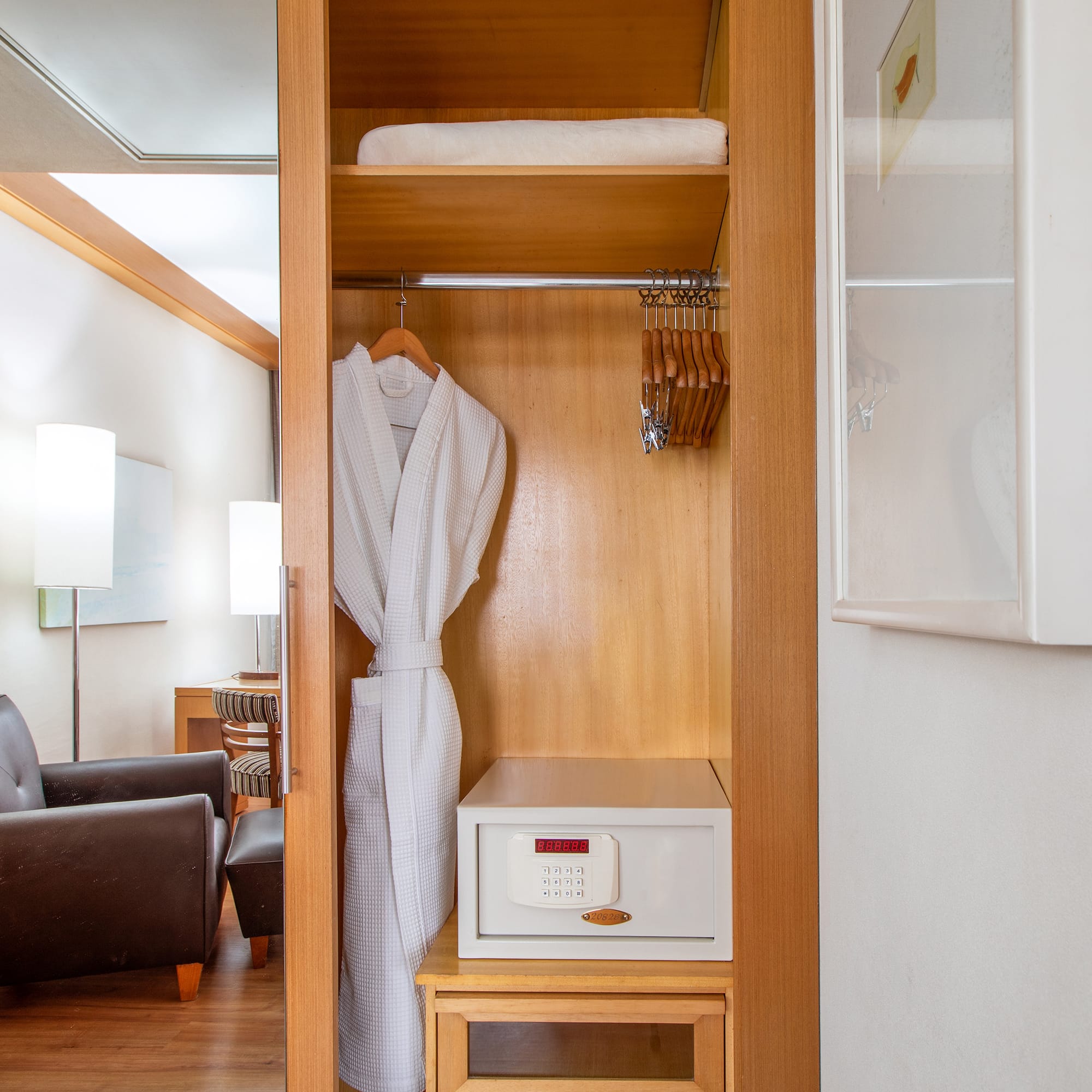 a white robe on a swinger in a closet