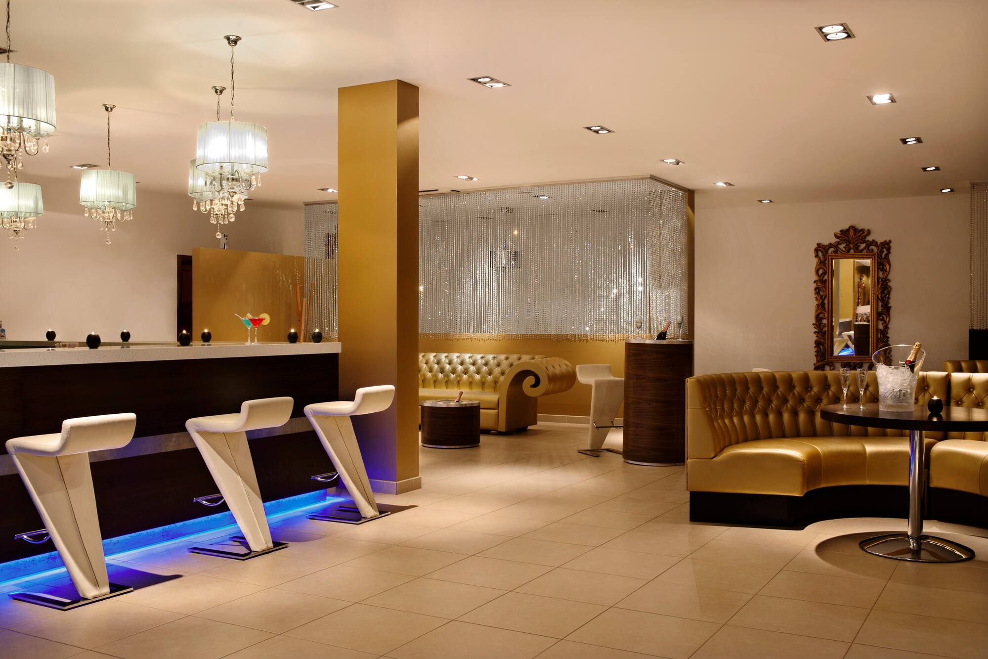 a room with a bar and chairs