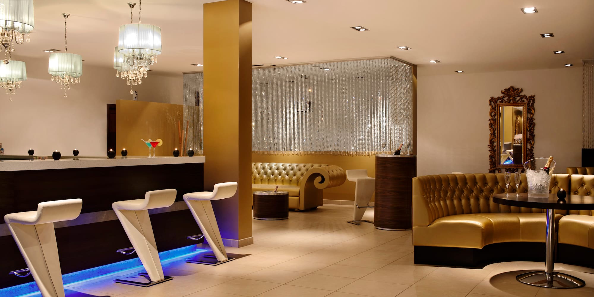 a room with a bar and chairs