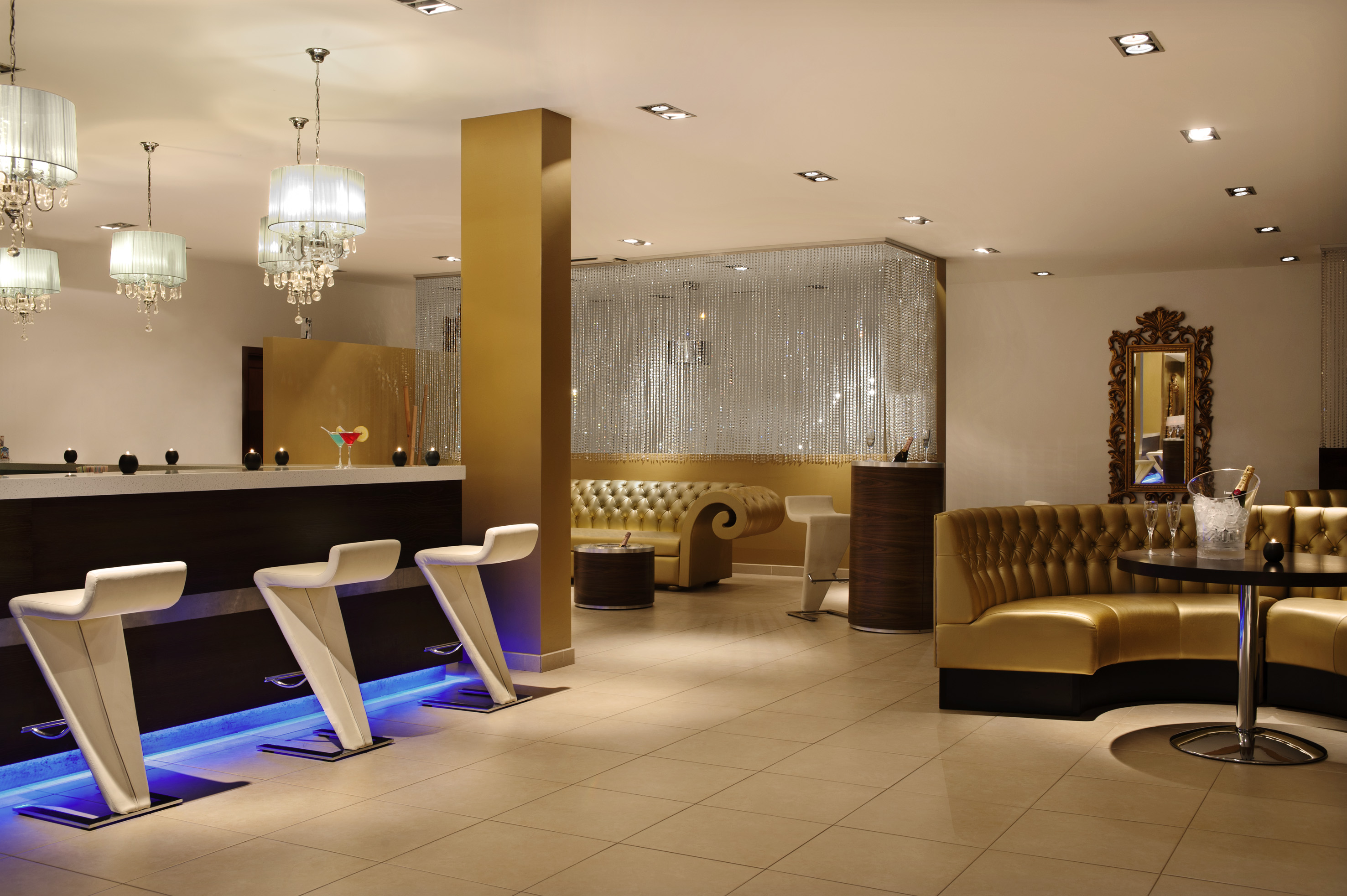 a room with a bar and chairs