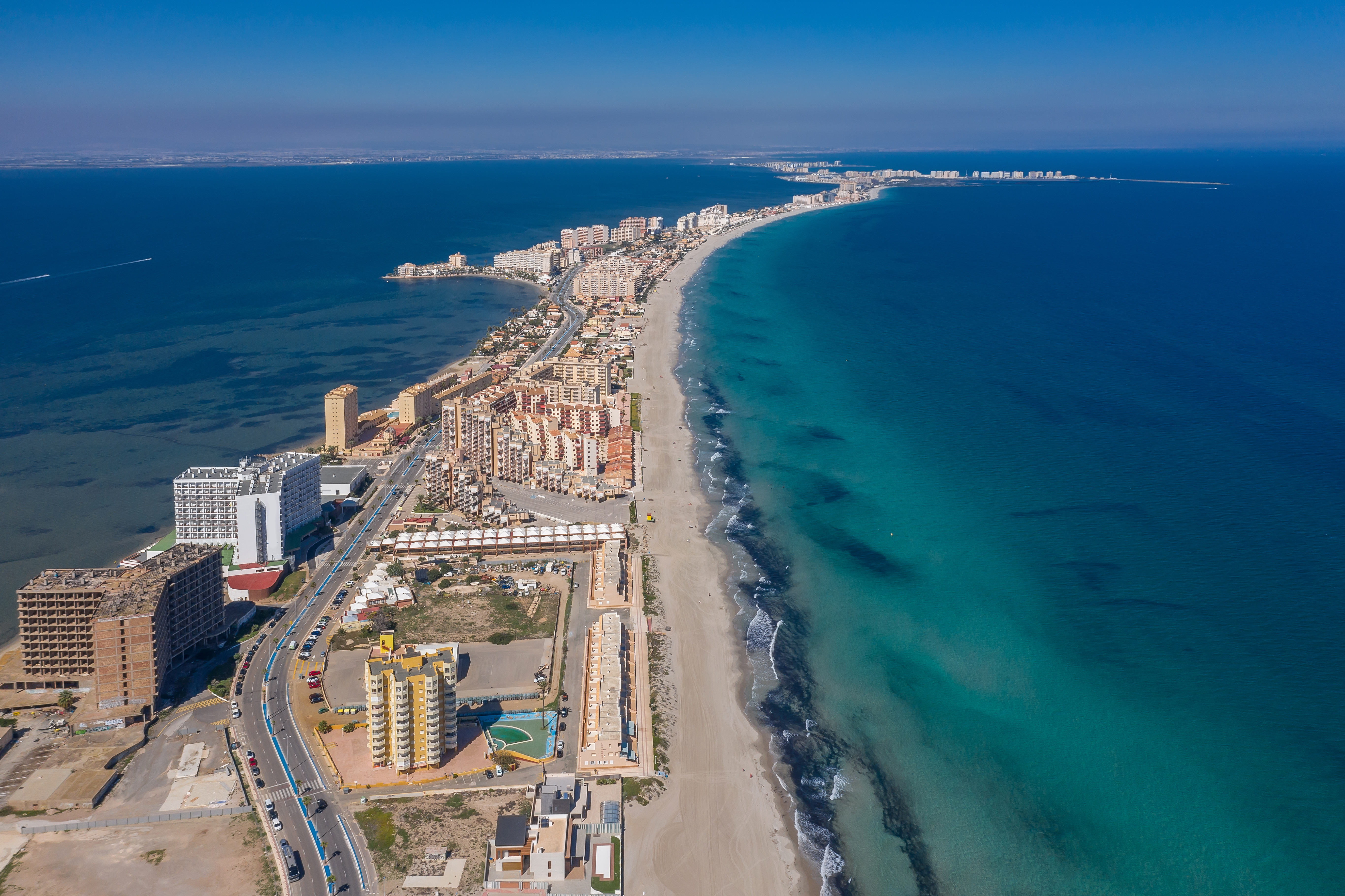 a beach with buildings and a body of water