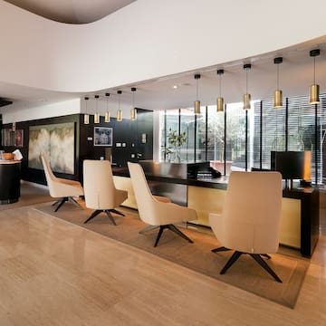 a room with a reception desk and chairs