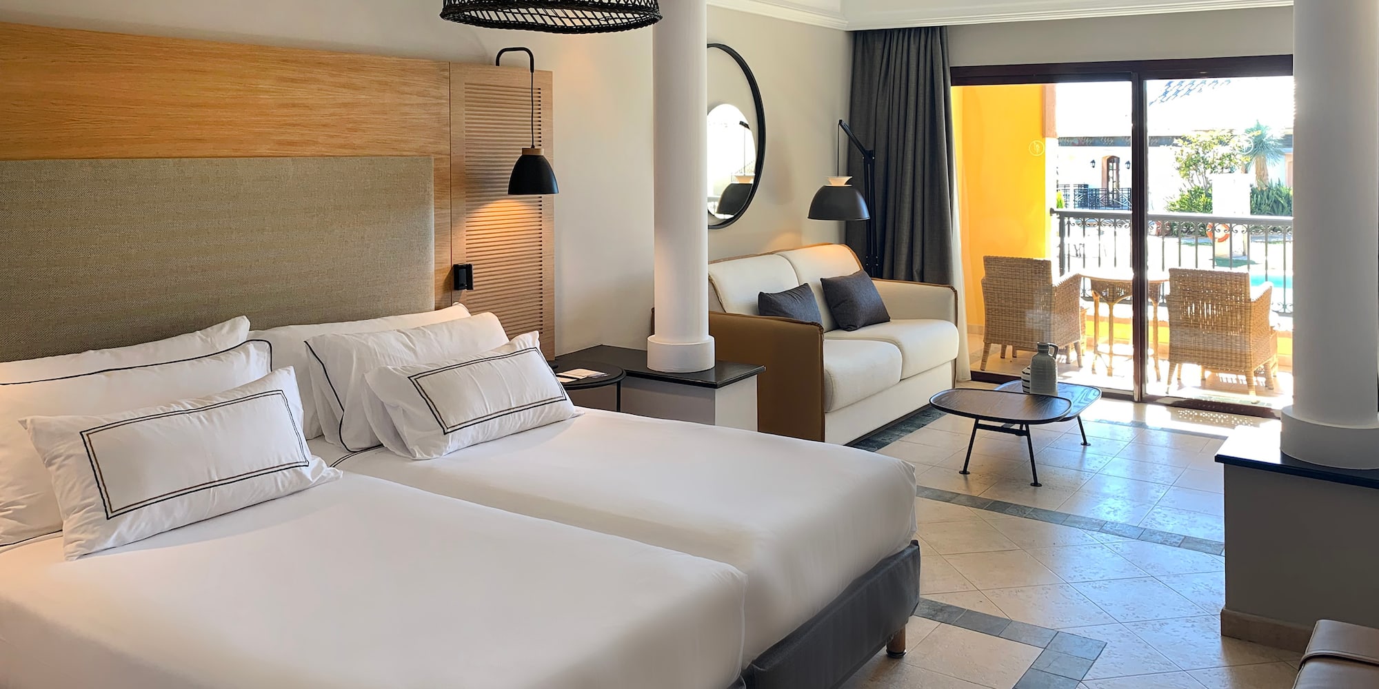 a room with two beds and a balcony