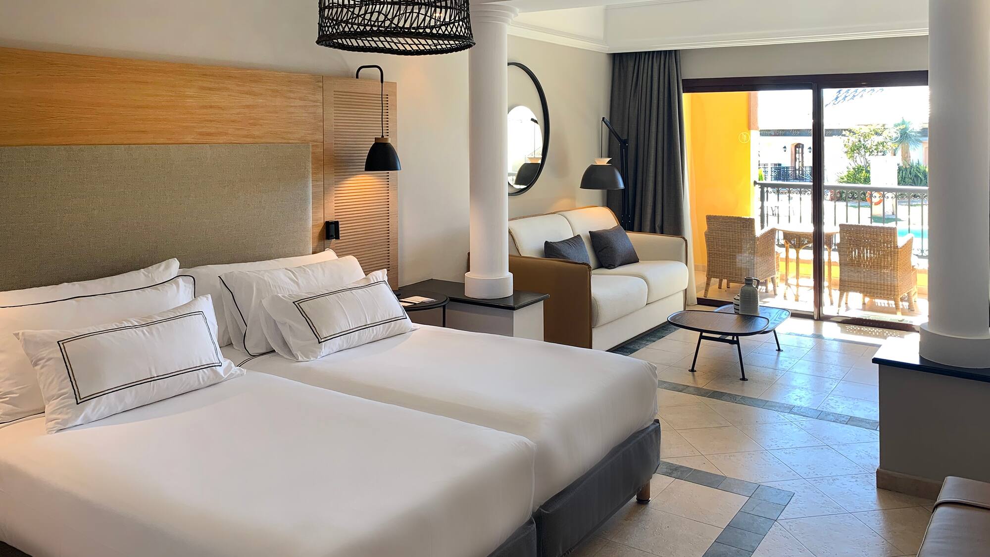 a room with two beds and a balcony