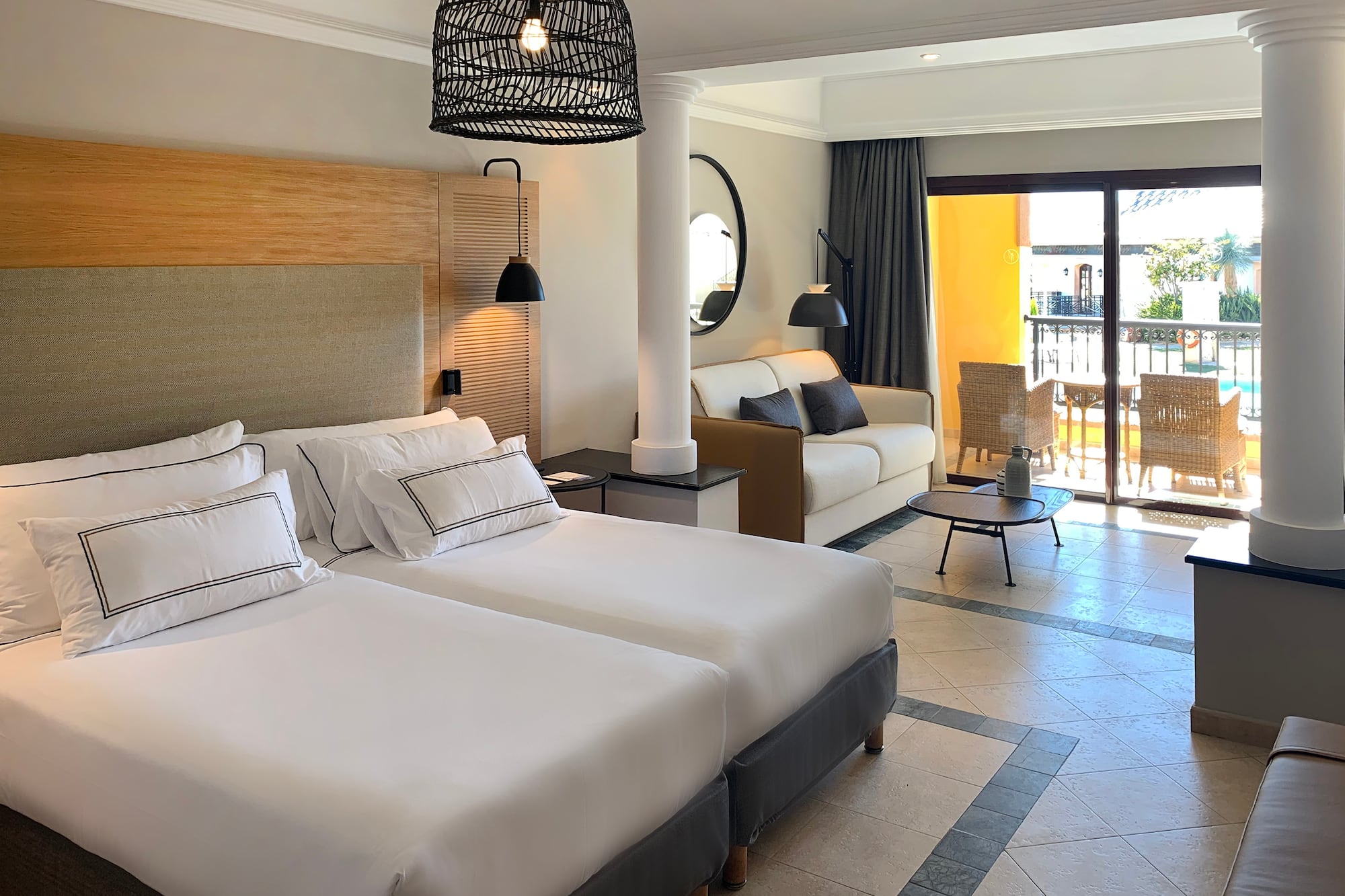 a room with two beds and a balcony