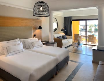 a room with two beds and a balcony