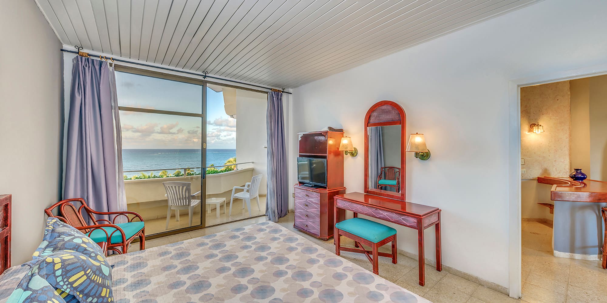 a room with a mirror and dresser