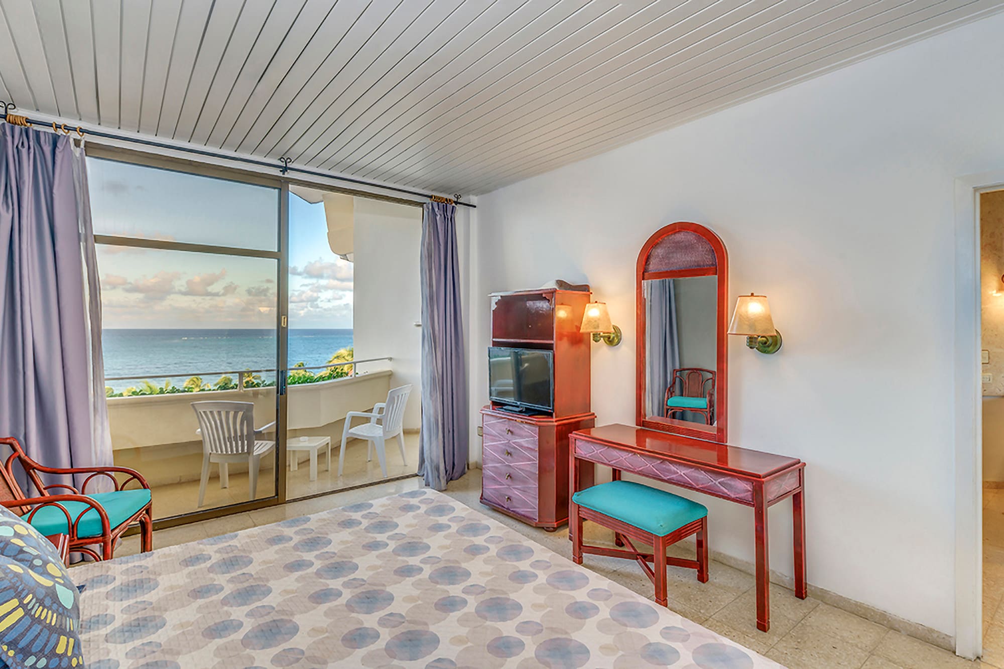 a room with a mirror and dresser