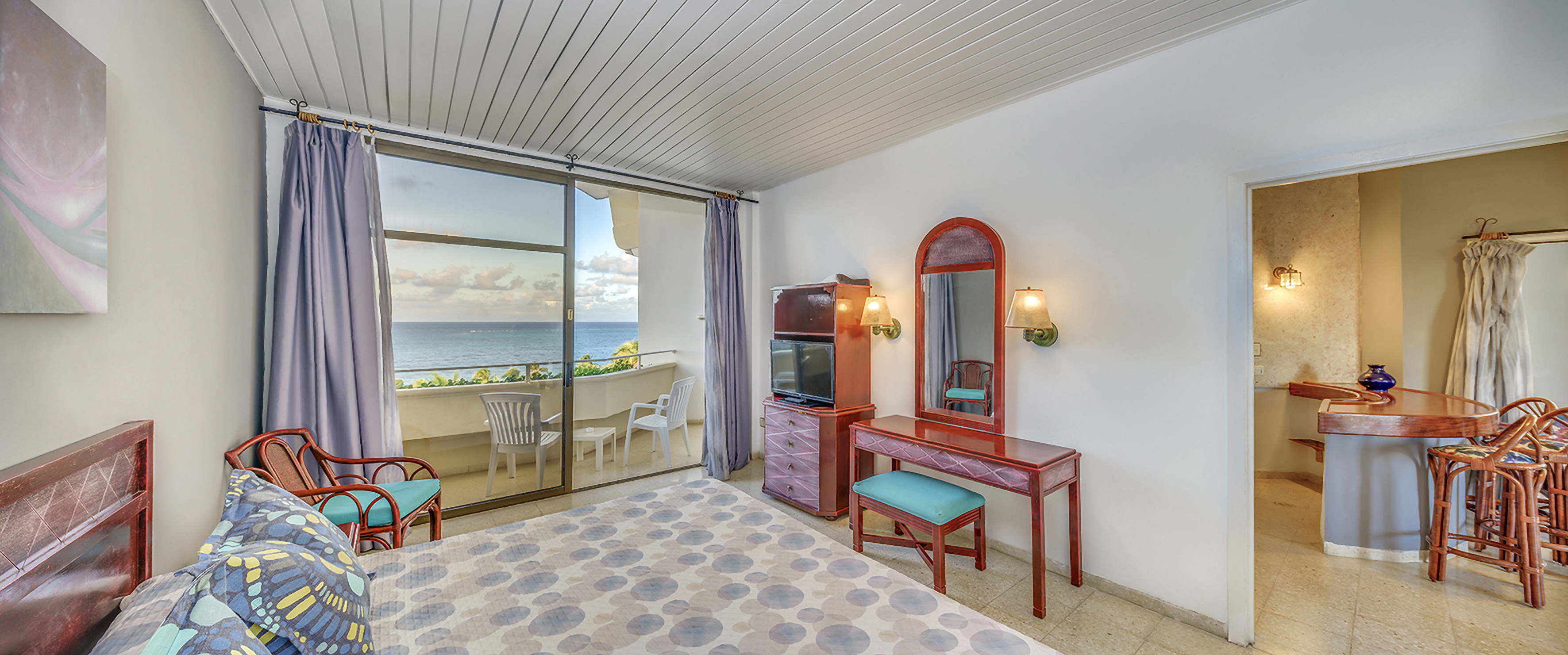 a room with a mirror and dresser