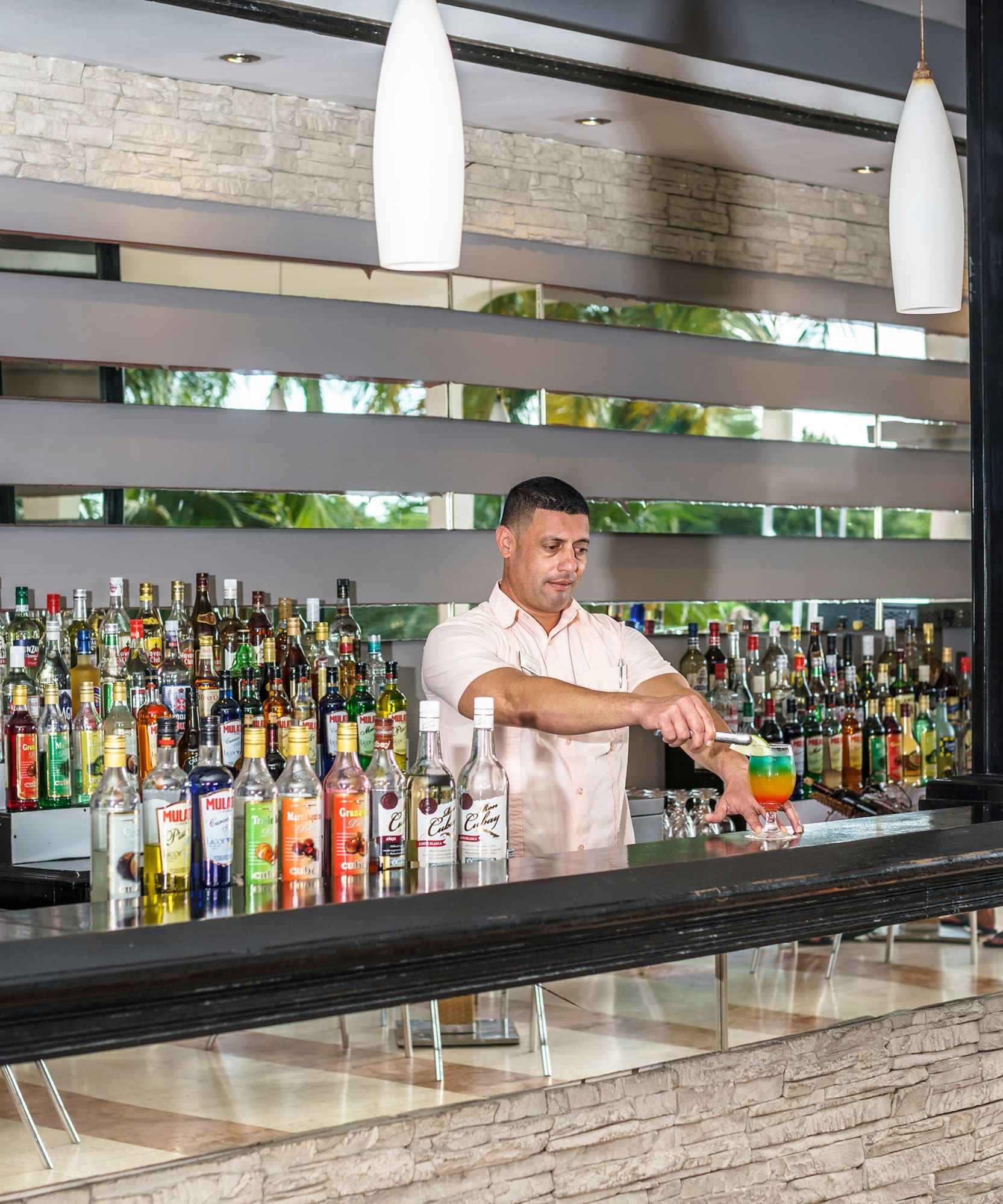 a man standing behind a bar