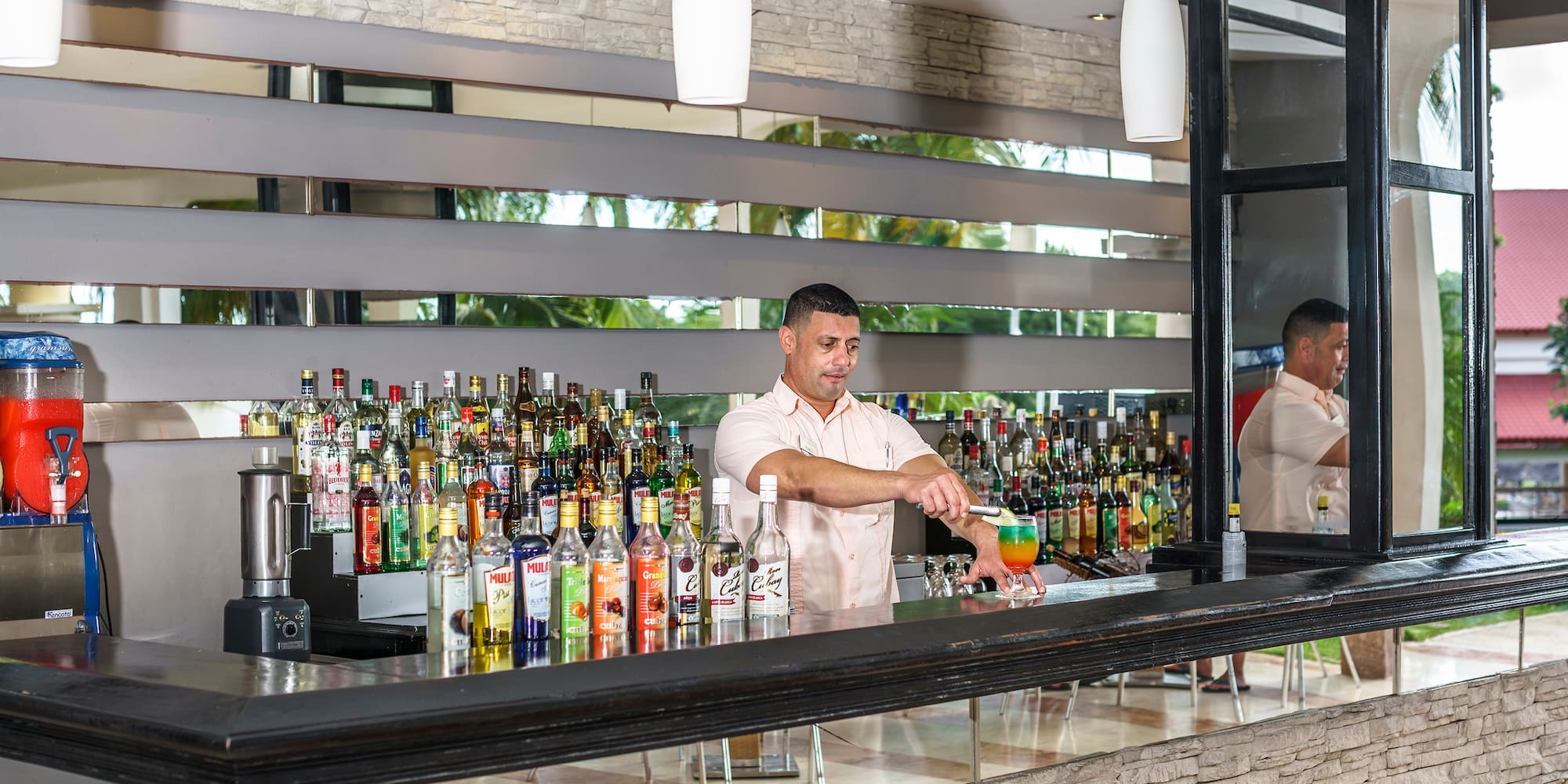 a man standing behind a bar