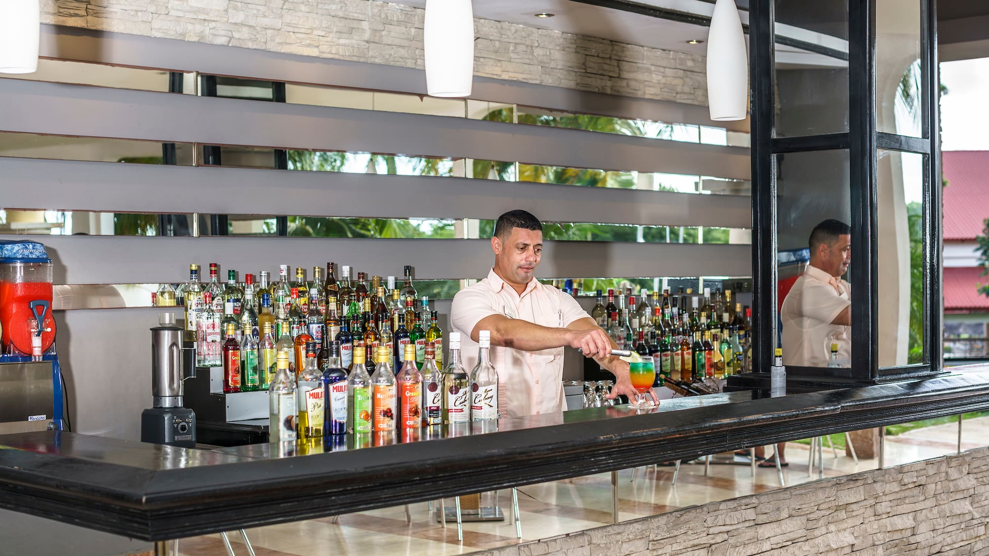 a man standing behind a bar
