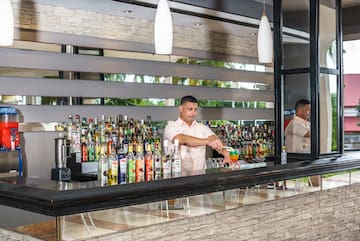 a man standing behind a bar