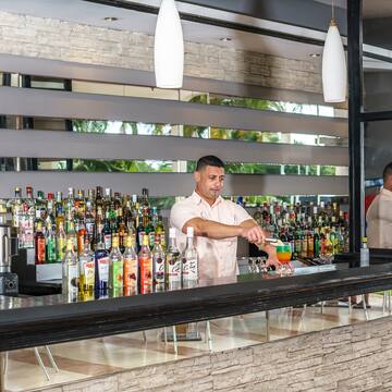 a man standing behind a bar