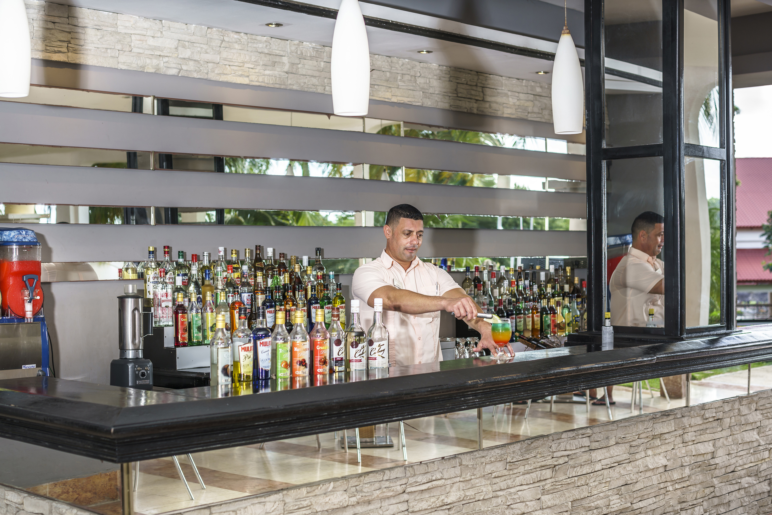 a man standing behind a bar