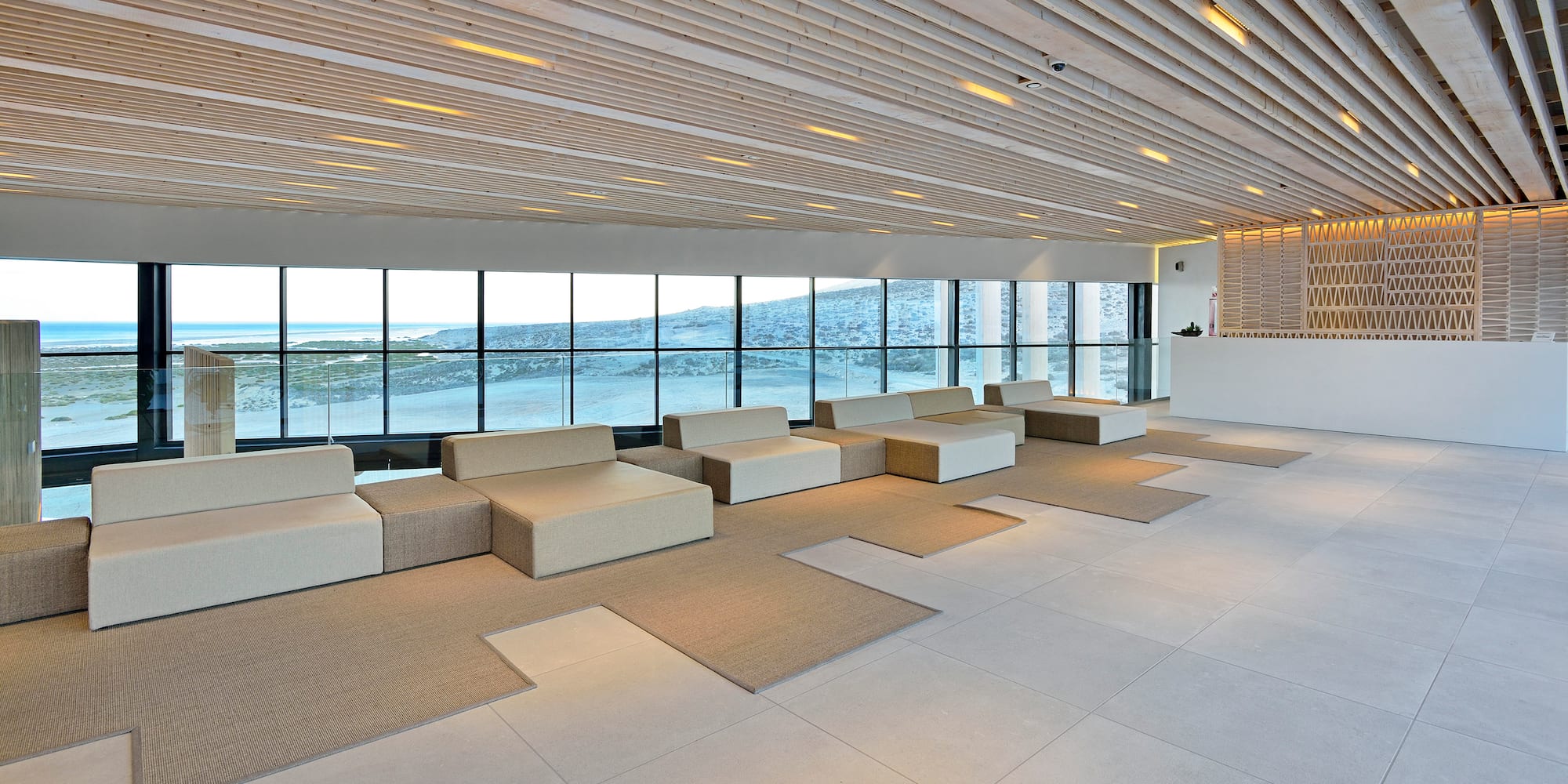 a large room with white furniture and large windows