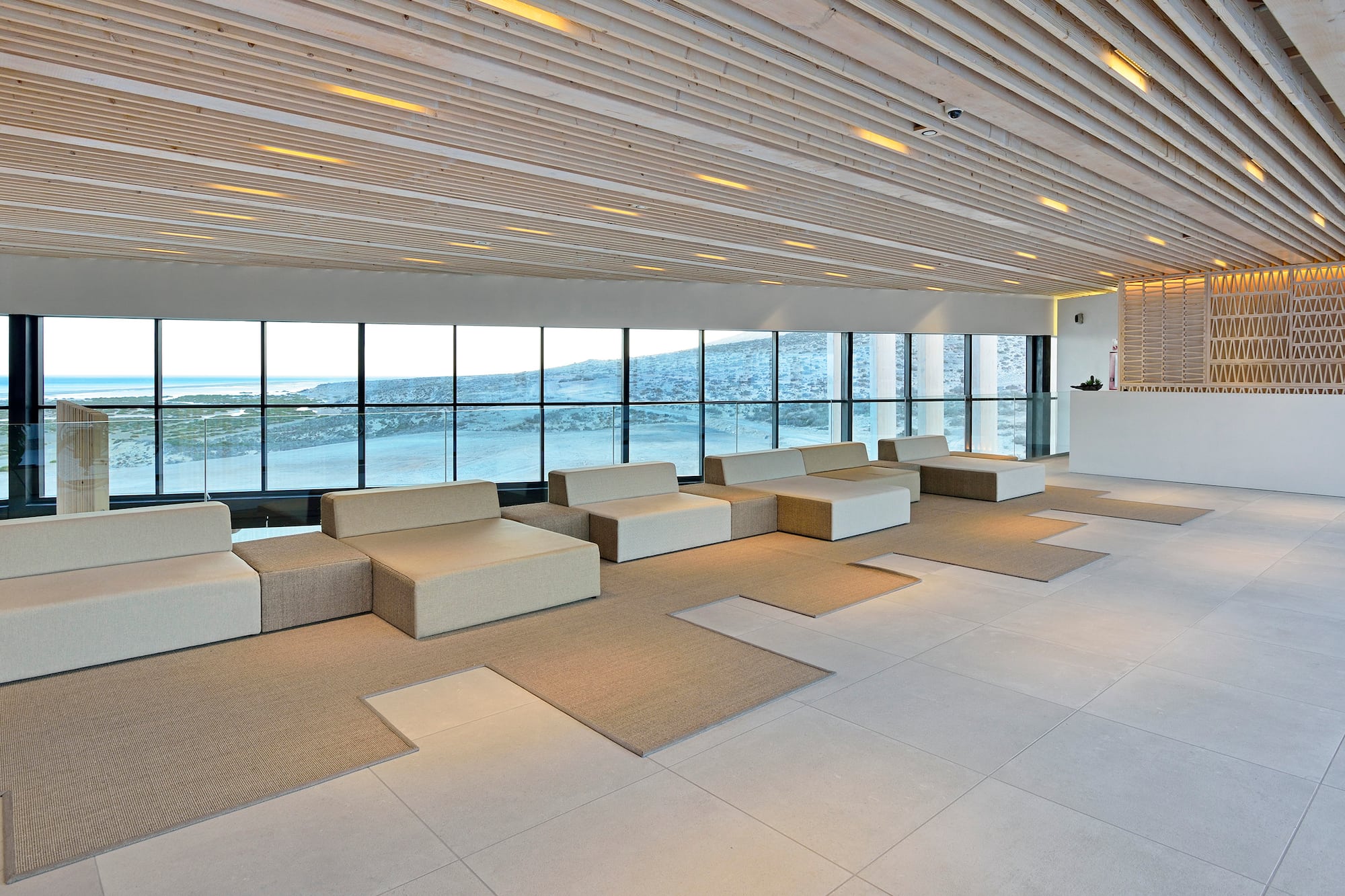 a large room with white furniture and large windows