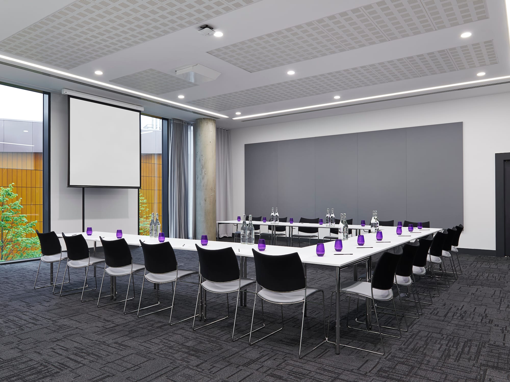 a room with a large table and chairs