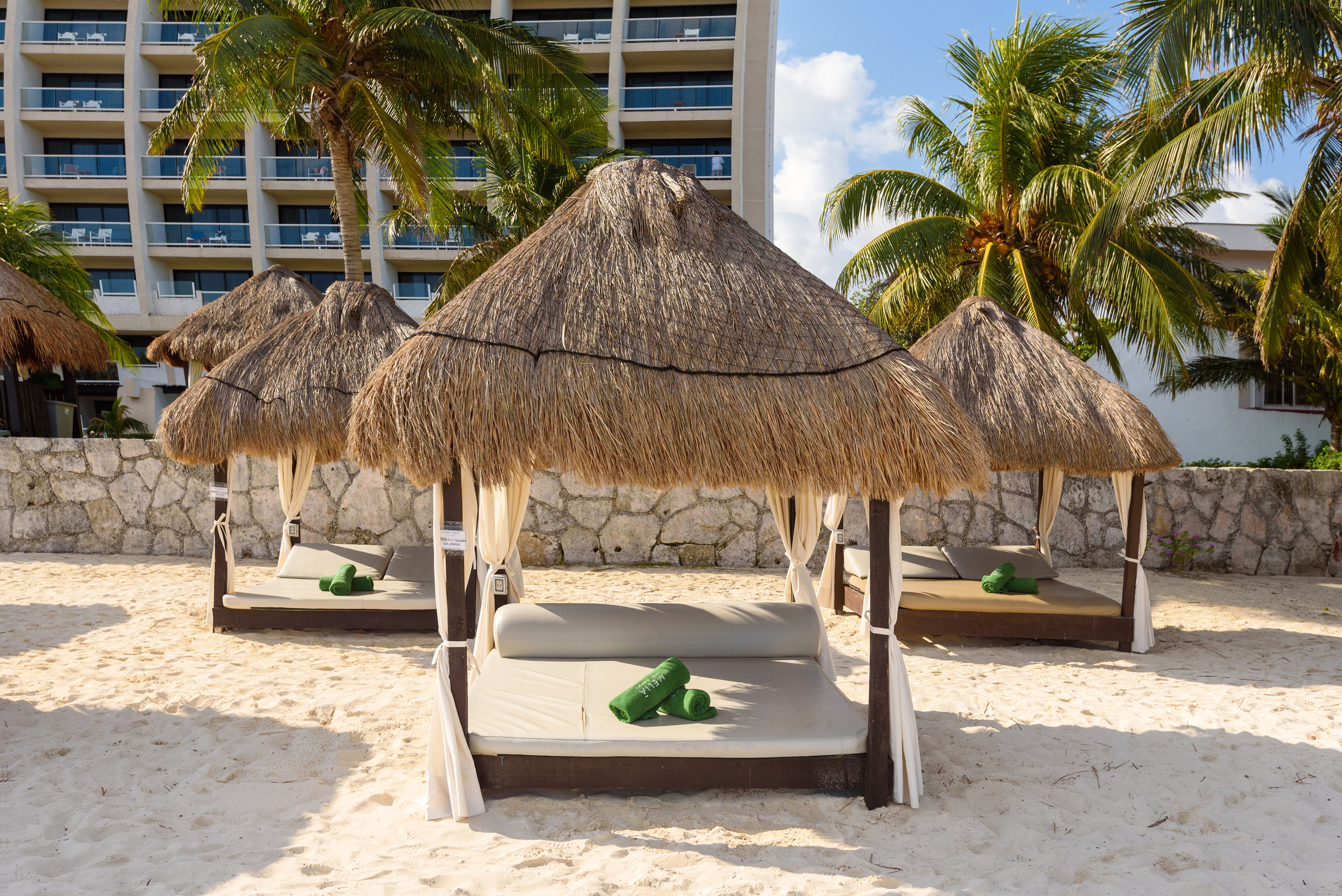 a group of lounge chairs on a beach