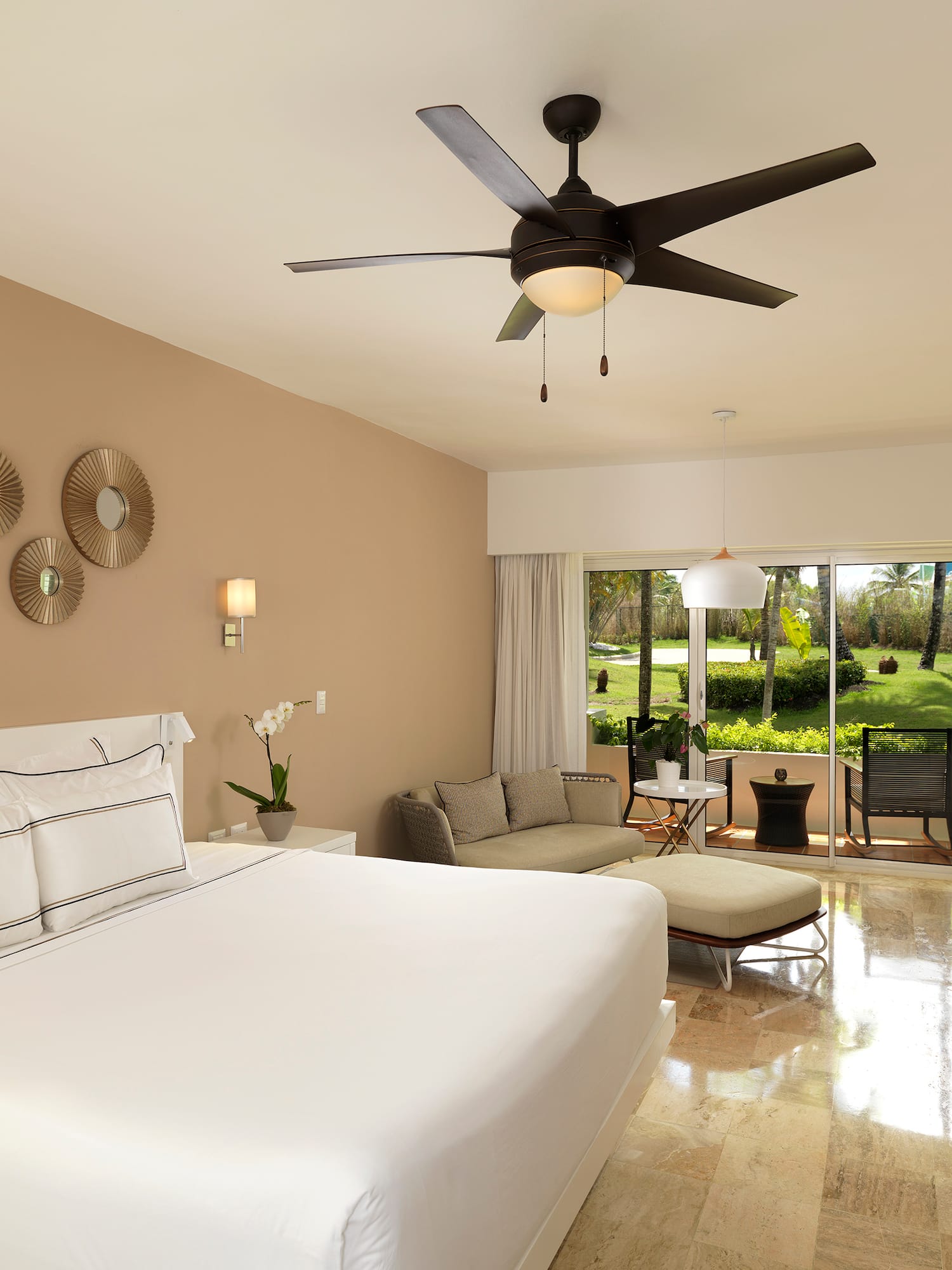 a room with a bed and a ceiling fan