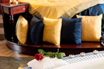 a rose on a pillow on a bathtub