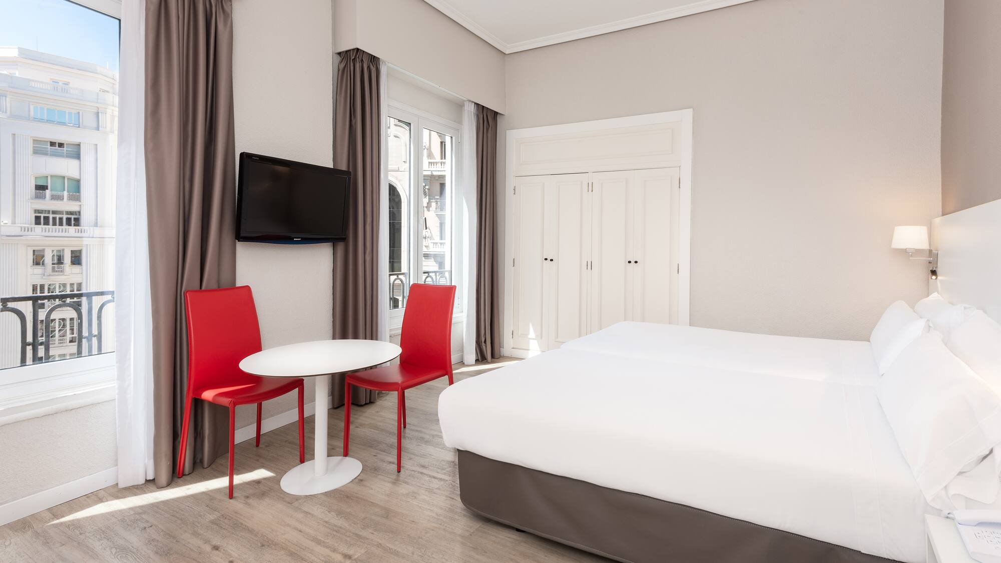 a room with a bed and a table and chairs