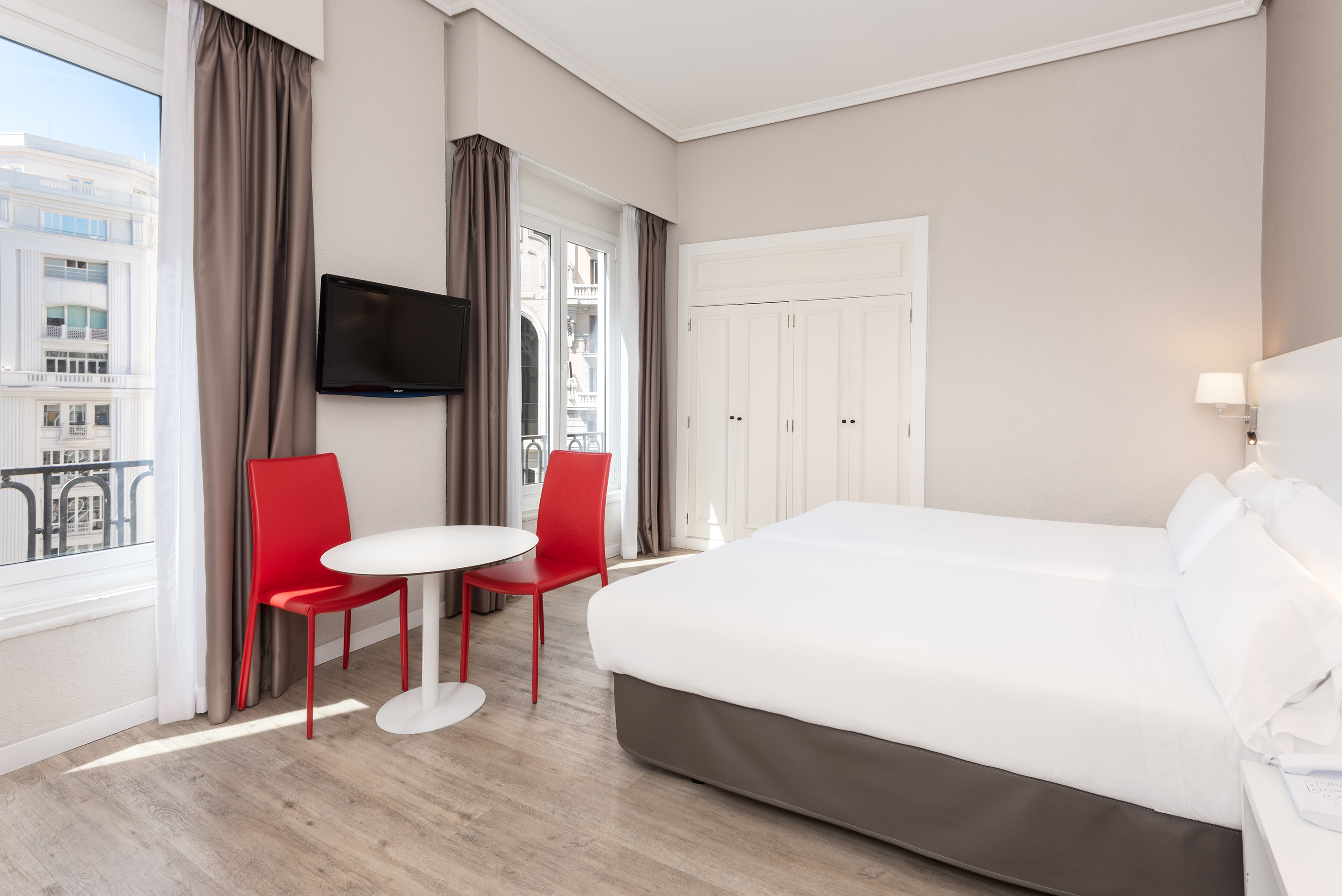 a room with a bed and a table and chairs