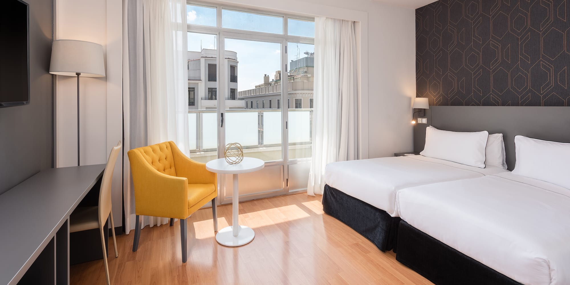 a room with a bed and a table and chairs