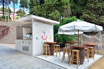 a white building with tables and umbrellas