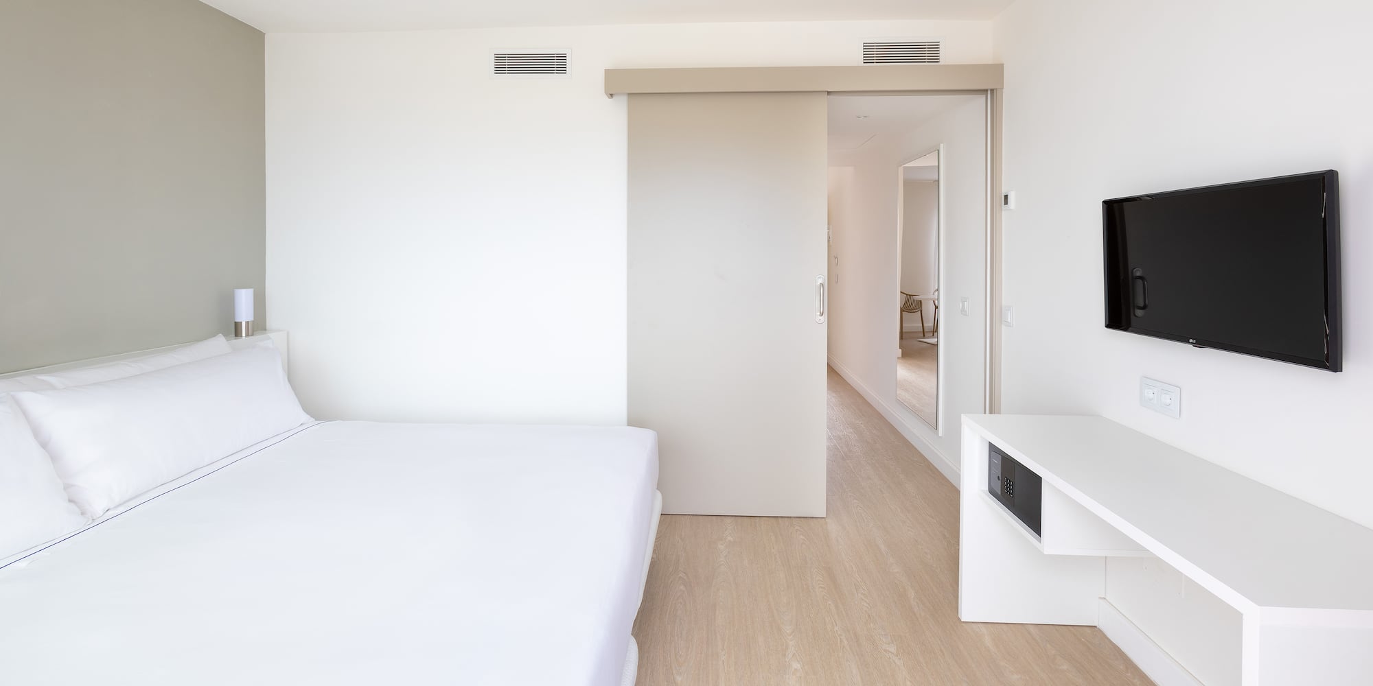 a bedroom with a bed and a tv